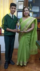 Principal, Monica Ma'am with student receiving award.